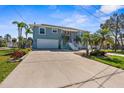Two-story home with a spacious driveway, two car garage, and beautiful landscaping at 8408 Damen Ln, Port Richey, FL 34668