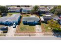 Charming single-story home with blue paint, red shutters, and a well-maintained front lawn at 10245 Regency Park Blvd, Port Richey, FL 34668