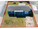 Charming single-story home with blue paint, red shutters, and a well-maintained front lawn at 10245 Regency Park Blvd, Port Richey, FL 34668