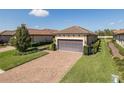 Charming one-story home with a two-car garage, paver driveway and manicured landscaping at 11383 Callisia Dr, Odessa, FL 33556