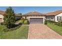 Charming one-story home with a two-car garage, paver driveway and manicured landscaping at 11383 Callisia Dr, Odessa, FL 33556