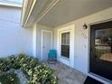 Welcoming front entrance featuring a tiled porch, seating, and verdant landscaping at 12205 Darwood Dr # 12205, Hudson, FL 34667