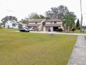 Two-story townhouses with neutral exteriors, garages, and green lawns at 12401 Joel Ct, Tampa, FL 33612