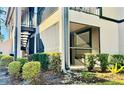 Exterior view of a two story home with a screened in patio area and lush landscaping at 14736 Norwood Oaks Dr # 103, Tampa, FL 33613