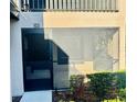 Exterior view of a home with a screened in patio area and unit number for easy identification at 14736 Norwood Oaks Dr # 103, Tampa, FL 33613