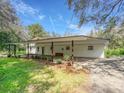 Well-maintained single-story home featuring a covered carport, brick facade, and manicured landscaping for a welcoming appeal at 14821 Sassandra Dr, Odessa, FL 33556
