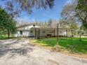 Inviting single-story home with a covered entrance and well-maintained landscaping for enhanced curb appeal and charm at 14821 Sassandra Dr, Odessa, FL 33556