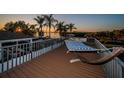 Outdoor deck with hammock, railing, and views of the water at 1616 Sea Breeze Dr, Tarpon Springs, FL 34689