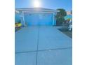 Exterior shot of the residence, featuring a two-car garage, blue paint, and a spacious driveway at 2931 Walnut Grove Ct, Holiday, FL 34691