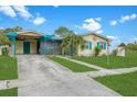 Exterior of a cozy home featuring vibrant colors, a carport, and a well-manicured lawn at 4544 Cynthia Ln, Spring Hill, FL 34606