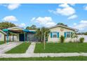 Charming home with vibrant exterior colors, a carport, and a well-kept lawn at 4544 Cynthia Ln, Spring Hill, FL 34606