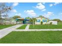 Quaint home with colorful accents, a large front yard, and inviting curb appeal at 4544 Cynthia Ln, Spring Hill, FL 34606