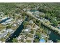 Waterfront home in tranquil community, lush trees along the canal waterways, showcasing serene coastal living at 5319 Ray Dr, Weeki Wachee, FL 34607