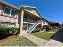 Exterior of condo with landscaping, stairs, and second story balcony at 6533 Spring Flower Dr # 15, New Port Richey, FL 34653