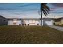 Single-story home with an attached garage, bright exterior, and tidy lawn at 6627 Leeside Isle, Hudson, FL 34667