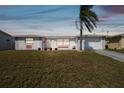 Charming single-story home with a well-maintained lawn and attached garage showcasing curb appeal at 6627 Leeside Isle, Hudson, FL 34667