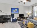 Stylish living room featuring a piano, accent chair and comfortable sofas at 6741 Citrus Creek Ln, Tampa, FL 33625