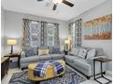 Comfortable living room with modern furniture and patterned curtains at 6741 Citrus Creek Ln, Tampa, FL 33625