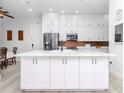 Modern kitchen features a large island, white cabinets, stainless steel appliances, and updated fixtures at 700 S Harbour Island Blvd # 807, Tampa, FL 33602