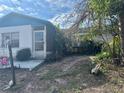 Home featuring mature landscaping, a cozy porch, and a welcoming entrance at 7278 Lamplighter St, Spring Hill, FL 34606