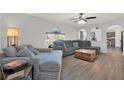 Cozy living room featuring a plush sectional sofa and hardwood floors at 9291 Geranium Ave, Spring Hill, FL 34606