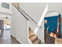 Well-lit staircase with carpeted steps and modern railing, leading to the upper level at 9291 Geranium Ave, Spring Hill, FL 34606