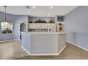 Open kitchen features bright cabinets, spacious counters and neutral walls at 11257 Frigate Bird Ave, Weeki Wachee, FL 34613