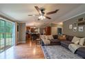 An open concept living room with dark wood floors and access to the back deck at 13024 Mohican Ave, New Port Richey, FL 34654