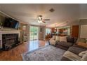 Inviting living room features a fireplace, hardwood floors, and abundant natural light at 13024 Mohican Ave, New Port Richey, FL 34654