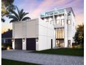 Modern home featuring a three-car garage, clean lines, and high ceilings, providing a luxurious curb appeal at 145 5Th N Ave, St Petersburg, FL 33701