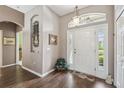 Bright foyer featuring hardwood floors, an arched entryway, and a view of the front door at 18129 Baywood Forest Dr, Hudson, FL 34667