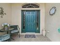Stylish front door with sidelights and a decorative transom window, creating a welcoming entrance at 18129 Baywood Forest Dr, Hudson, FL 34667