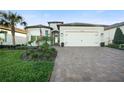 Charming single-Gathering home boasting a brick paved drive and meticulously landscaped front yard at 19742 Sea Glass Cir, Land O Lakes, FL 34638