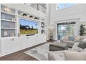 Open-concept living room featuring a built-in entertainment center and backyard access at 2830 Dudley Ave, Odessa, FL 33556