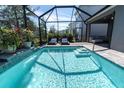 A beautiful screened-in pool with two lounge chairs at 2830 Dudley Ave, Odessa, FL 33556