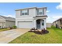 A beautiful home showcases curb appeal with its manicured lawn and attached two-car garage at 30845 Penny Surf Loop, Wesley Chapel, FL 33545