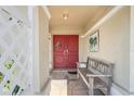 Inviting entryway with double doors, tiled floor, and a cozy bench at 4615 Elwood Rd, Spring Hill, FL 34609