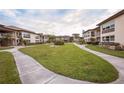 Landscaped community featuring condo buildings, sidewalks, and grassy common areas at 4712 Marine Pkwy # 104, New Port Richey, FL 34652
