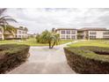 Condo complex exterior surrounded by landscaping and sidewalks throughout the community at 4712 Marine Pkwy # 104, New Port Richey, FL 34652