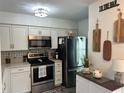 Well-equipped kitchen with stainless appliances, light cabinetry, and decor at 4925 Myrtle Oak Dr # 22, New Port Richey, FL 34653