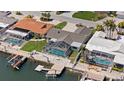 Waterfront home featuring a screened-in pool, boat dock, and beautifully landscaped yard, perfect for outdoor living at 5000 Galleon Ct, New Port Richey, FL 34652