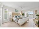 Bright main bedroom featuring a king bed, wood floors, and a cozy sitting area at 5000 Galleon Ct, New Port Richey, FL 34652