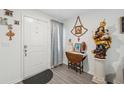 Bright entryway with neutral walls, gray floors and religious decorative items at 5388 Fez Ct, Brooksville, FL 34602