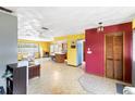 Open-concept living space with eat-in kitchen, colorful walls, and tiled flooring at 5441 Alderwood St, Spring Hill, FL 34606