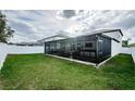 Exterior shot showing a screened patio and fenced yard at 6482 Beverly Hills Dr, Zephyrhills, FL 33541
