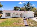 Charming single story home with arched entry, well manicured lawn and beautiful landscaping at 7048 Oberon Ave, Spring Hill, FL 34608