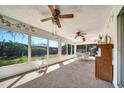Sunny sunroom with lots of windows offering backyard views and a cozy seating area at 8420 Winding Wood Dr, Port Richey, FL 34668