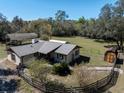 Aerial view of property with a fenced yard, shed, car port, and a view of the surrounding landscape at 9382 Wild Horse Trl, Brooksville, FL 34601