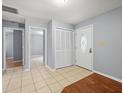 Bright foyer with tile flooring, closet space, and an entry door with decorative glass at 9382 Wild Horse Trl, Brooksville, FL 34601