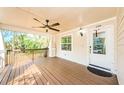 Spacious front porch with a ceiling fan, providing a perfect spot for relaxation and enjoying the outdoors at 120 Read St, Tarpon Springs, FL 34689